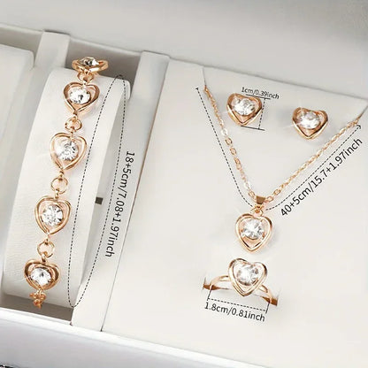 gold heart-shaped jewelry set with bracelet, necklace, ring, and earrings featuring clear stones