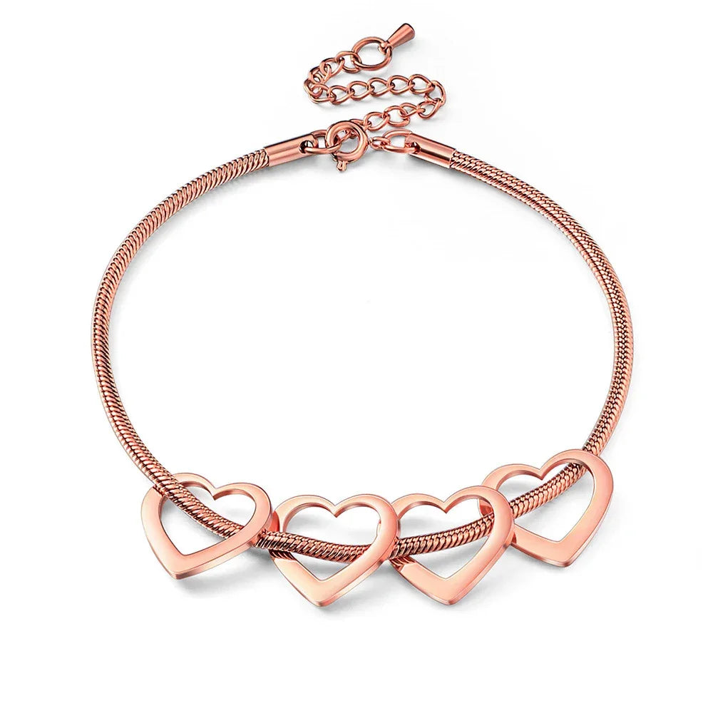 Rose gold bracelet with four open heart charms and adjustable chain clasp