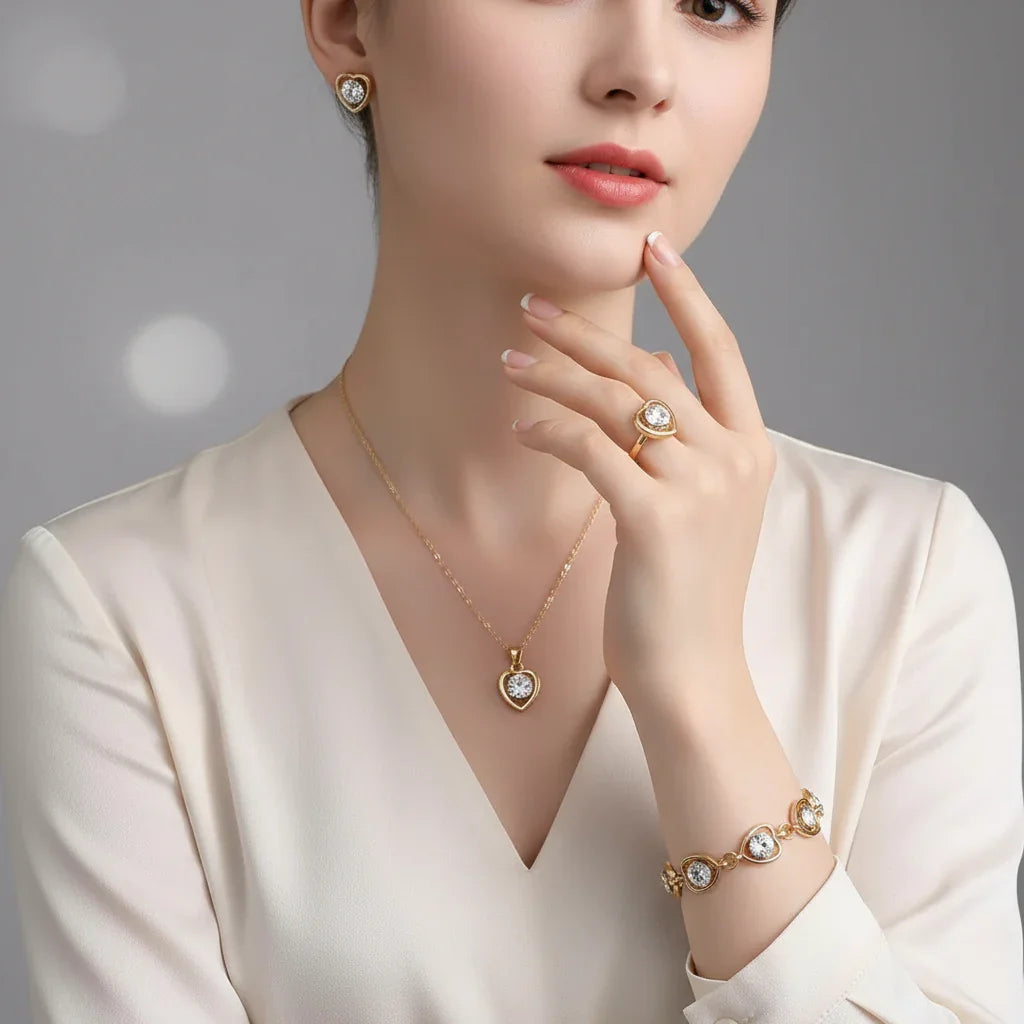 Elegant woman wearing matching gold heart-shaped diamond jewelry set with necklace, ring, earrings, and bracelet