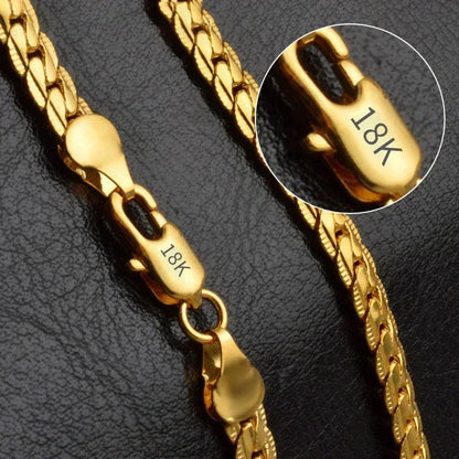 18K gold chain necklace clasp with close-up detail on black textured background