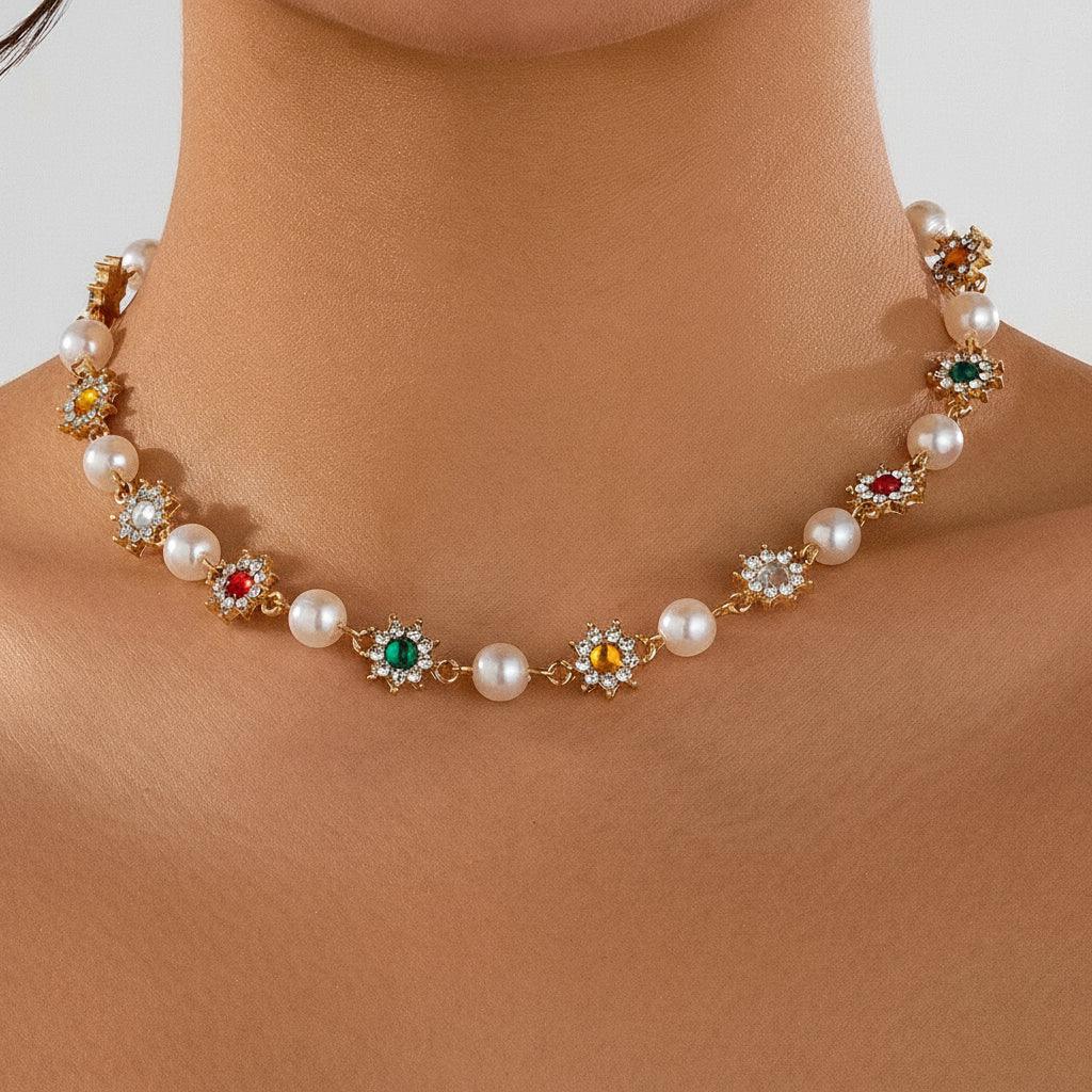Close-up of elegant necklace with pearls and multicolored gemstone flower pendants on neck