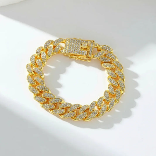 Gold Cuban link bracelet encrusted with sparkling diamonds on white surface